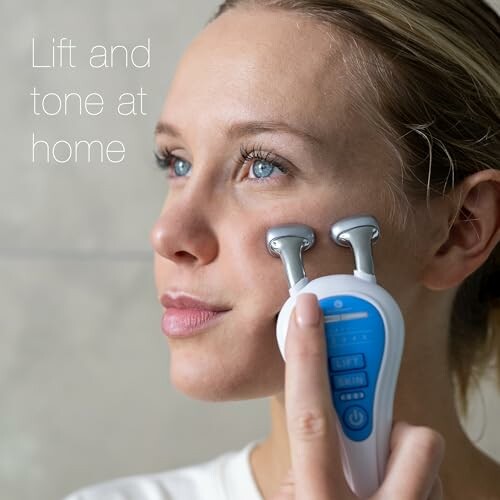 Woman using a facial toning device on her cheek.